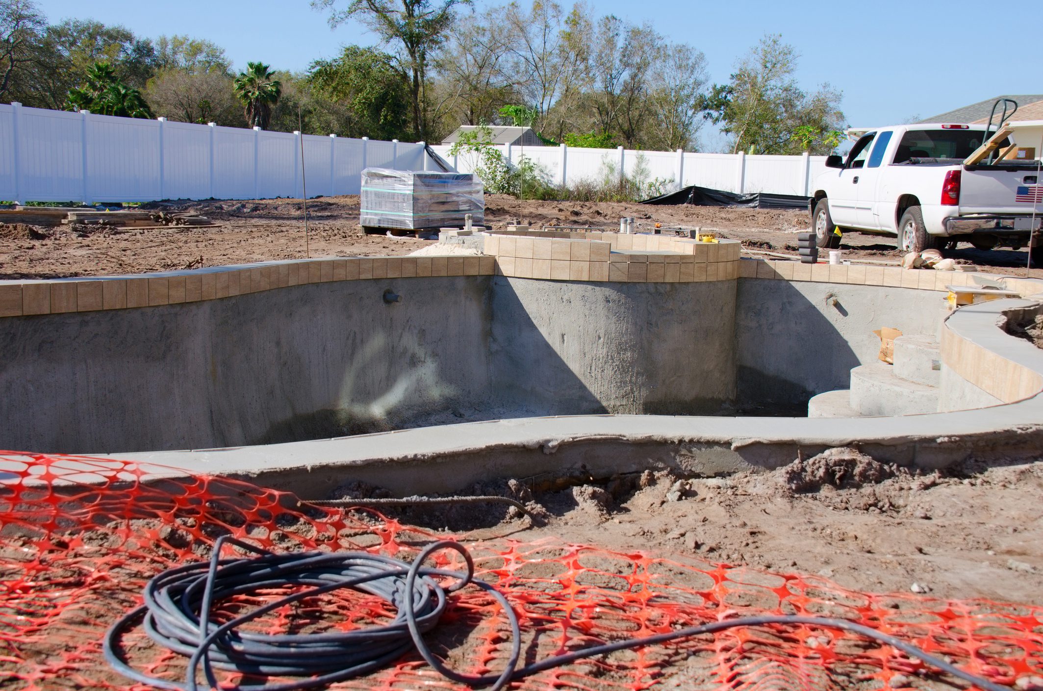 Construction site with unfinished swimming pool.