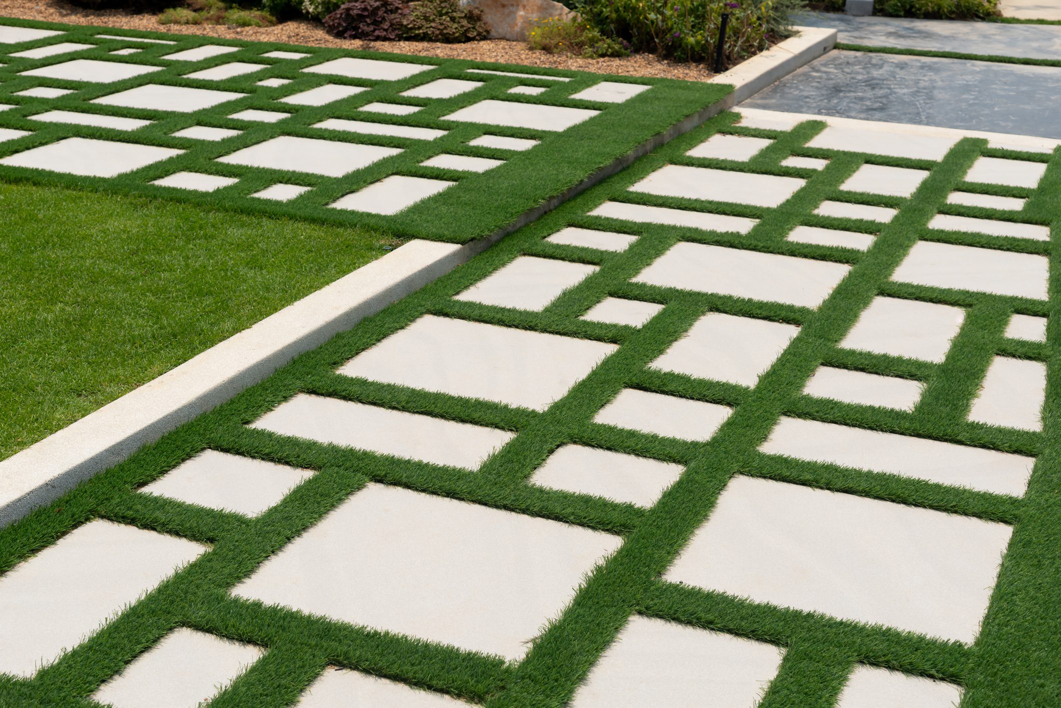 Texture or pattern of paving walkway with green grass.