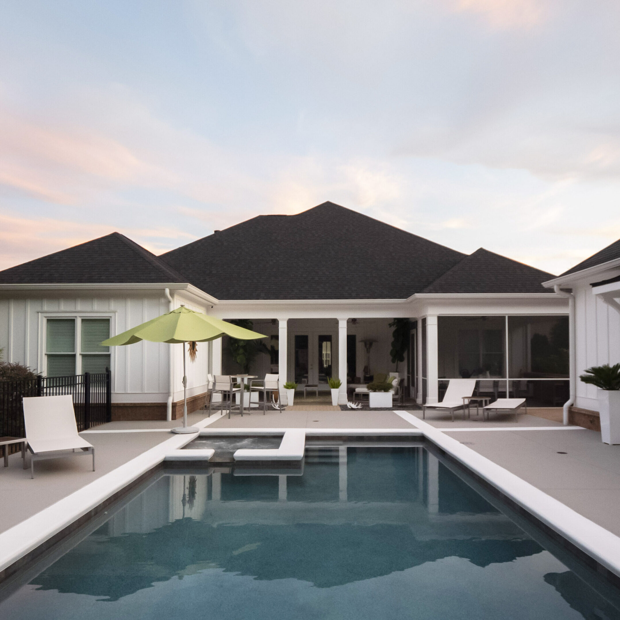 Modern house with a swimming pool at sunset.