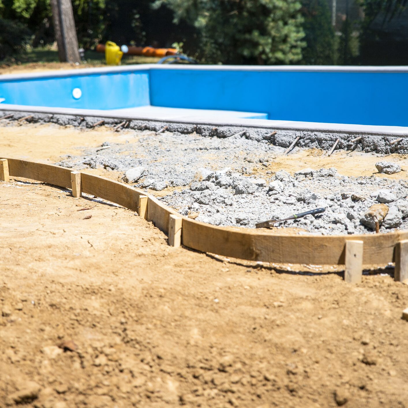 Swimming pool construction with concrete foundation.