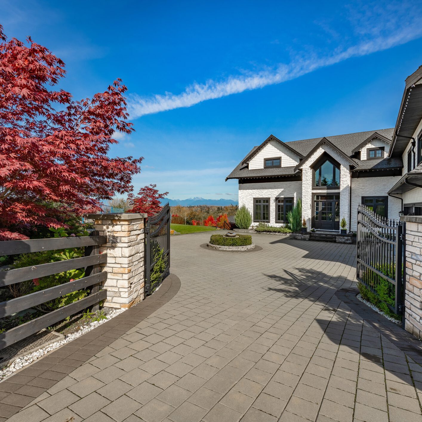 Modern house with driveway and landscaped garden.